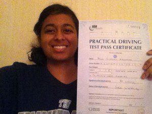 Simran holds her driving test pass certificate